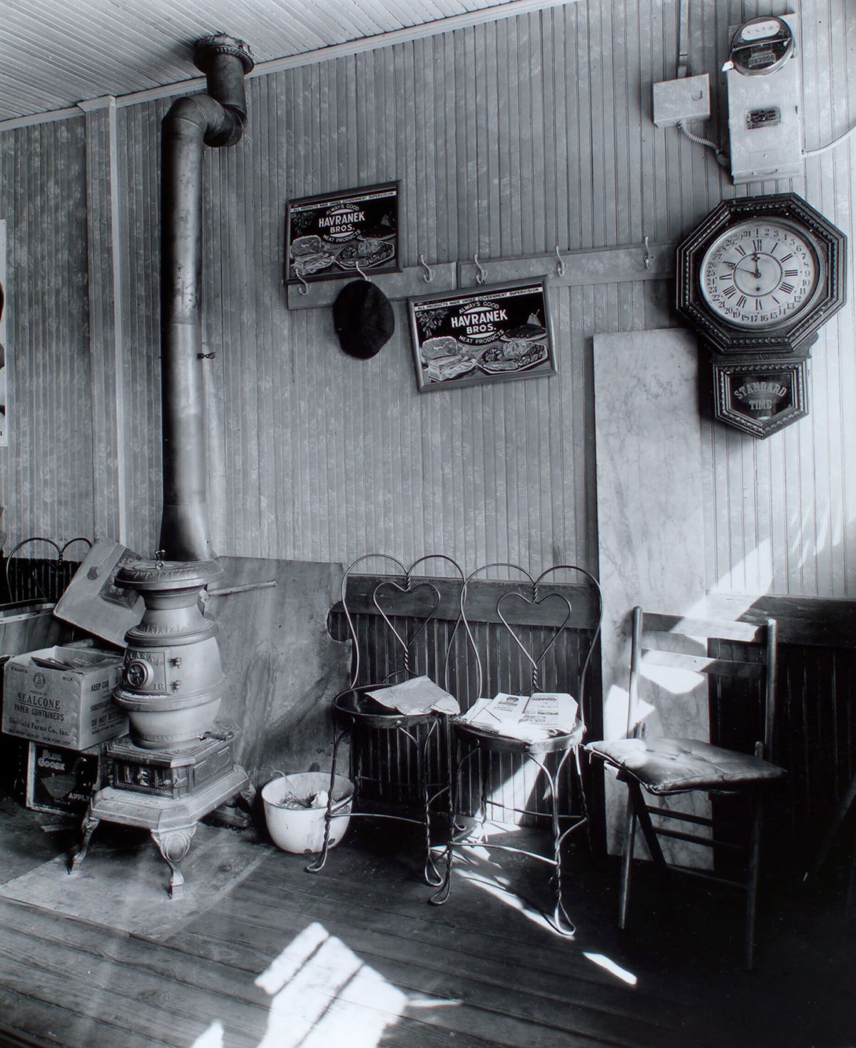Interior of an old country store with a pot-bellied stove and wall clock